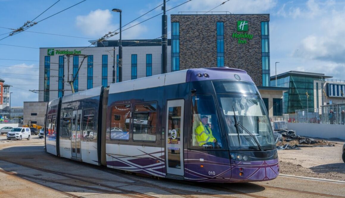 A photo showing a tram at the Talbot Gateway. In the background is a hotel and office building