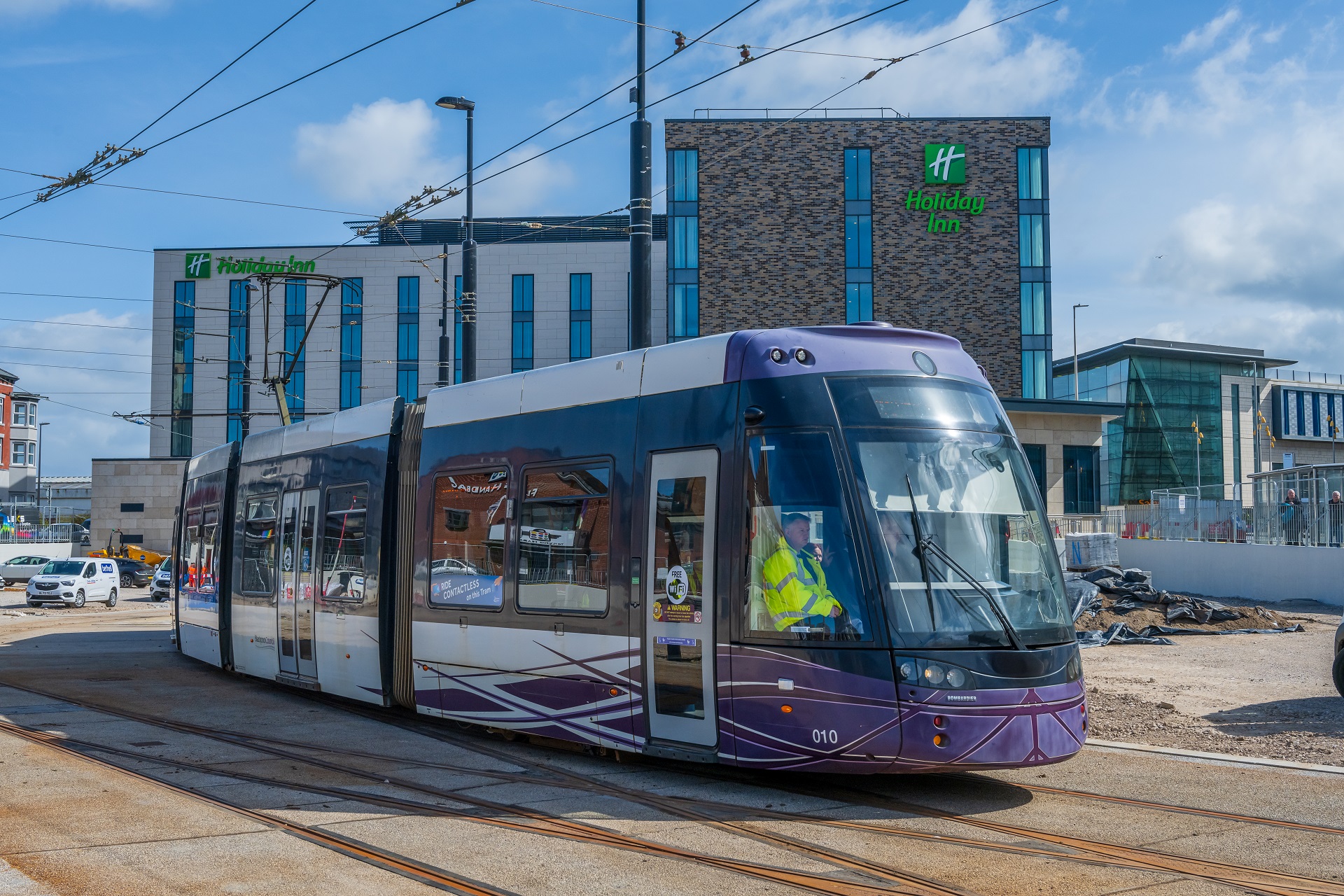A photo showing a tram at the Talbot Gateway. In the background is a hotel and office building